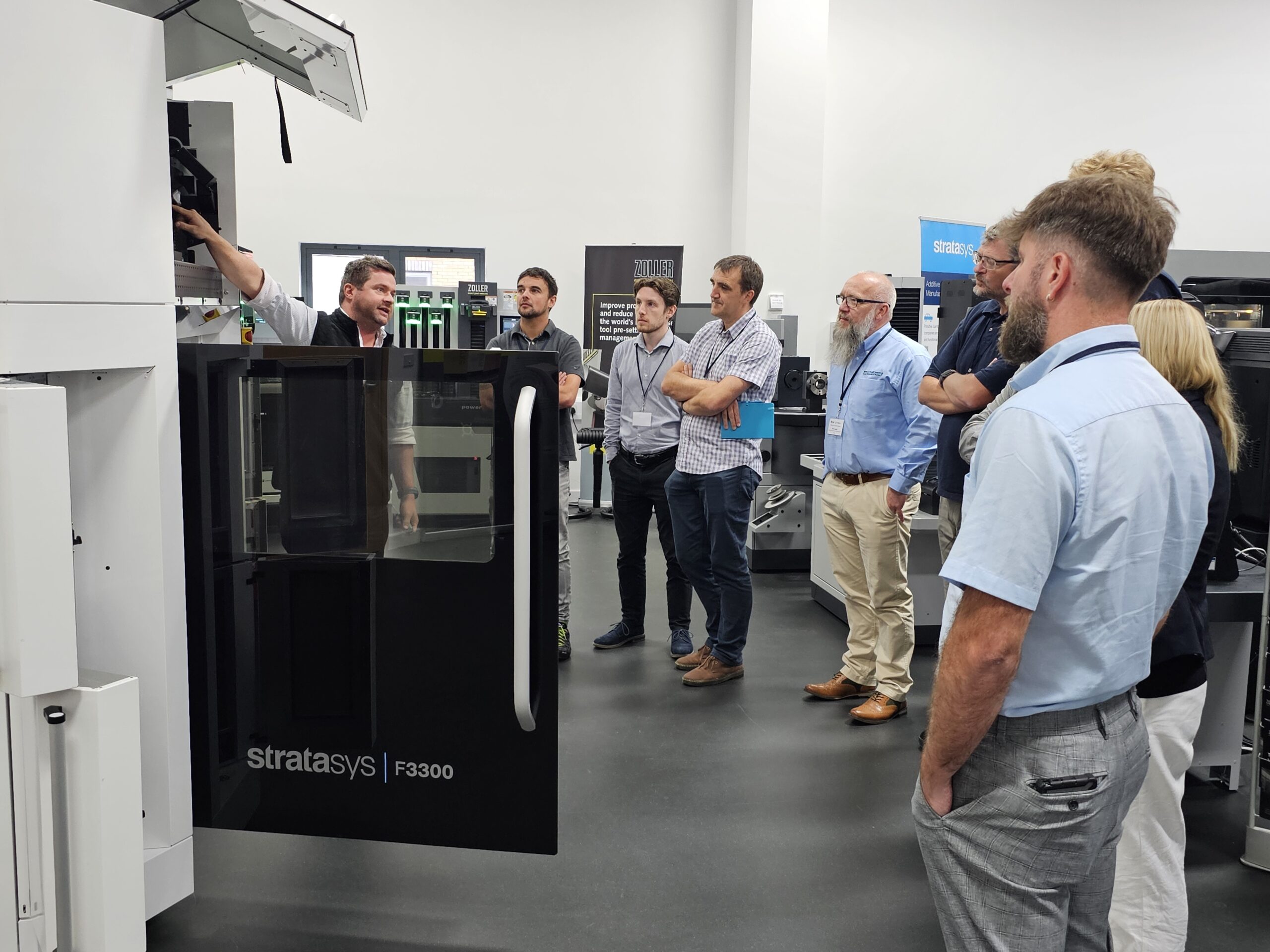 The sys team standing in front of the F3300 3d printer